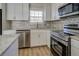 Updated kitchen with stainless steel appliances and mosaic backsplash at 912 Northridge Nw Dr, Conyers, GA 30012