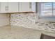 Close-up of a kitchen backsplash with a mix of neutral tones at 912 Northridge Nw Dr, Conyers, GA 30012