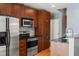 Modern kitchen with stainless steel appliances and wood cabinets at 943 Peachtree Ne St # 1109, Atlanta, GA 30309