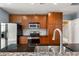 Modern kitchen with stainless steel appliances and wood cabinets at 943 Peachtree Ne St # 1109, Atlanta, GA 30309