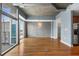 Hardwood floors and exposed concrete wall in living room at 943 Peachtree Ne St # 1109, Atlanta, GA 30309