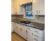 White cabinets, granite countertops, and tile floor at 116 E Wade St, Oxford, GA 30054