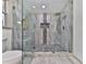 Walk-in shower with pebble tile floor and bench at 221 Wonewok Dr, Canton, GA 30114