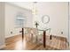 Bright dining room with hardwood floors, glass table, and white chairs at 3696 Winbrooke Ln, Tucker, GA 30084