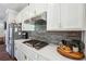 Modern kitchen with white cabinets, gas cooktop, and stainless steel appliances at 505 Stagecoach Bnd, Smyrna, GA 30080