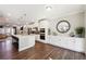 Open concept kitchen boasts white cabinets, stainless steel appliances, and hardwood floors at 505 Stagecoach Bnd, Smyrna, GA 30080