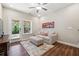 Living room with hardwood floors, patio access, and a comfy couch at 505 Stagecoach Bnd, Smyrna, GA 30080