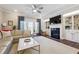 Spacious living room with sectional sofa, fireplace, built-in shelves, and hardwood floors at 505 Stagecoach Bnd, Smyrna, GA 30080