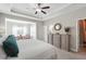 Main bedroom with tray ceiling, ceiling fan, and large dresser at 505 Stagecoach Bnd, Smyrna, GA 30080