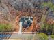 Aerial view of house, driveway, and wooded lot at 221 Heritage Town Pkwy, Canton, GA 30115
