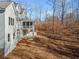 Side view of house showcasing backyard and wooded area at 221 Heritage Town Pkwy, Canton, GA 30115