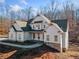 Two story farmhouse with white siding, stone accents, and a covered porch at 221 Heritage Town Pkwy, Canton, GA 30115