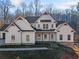 Two-story farmhouse with white siding, stone accents, and a covered porch at 221 Heritage Town Pkwy, Canton, GA 30115