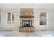Stone fireplace with a wood mantel in the living room at 221 Heritage Town Pkwy, Canton, GA 30115