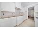 White kitchen cabinets and a range hood at 221 Heritage Town Pkwy, Canton, GA 30115