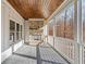 Covered porch with stone fireplace and wooded views at 221 Heritage Town Pkwy, Canton, GA 30115