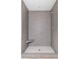 Walk-in shower with gray tile and built-in seat at 221 Heritage Town Pkwy, Canton, GA 30115