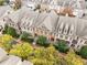 Aerial view of townhouses, tree-lined street at 2317 Saint Davids Nw Sq, Kennesaw, GA 30152