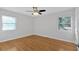 Spacious bedroom with hardwood floors and two windows at 3667 Prince Way, Tucker, GA 30084