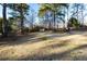 Expansive backyard with mature trees providing shade and privacy, ideal for outdoor relaxation at 1830 Brandy Se Ln, Conyers, GA 30013