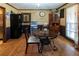 Spacious dining area with wood flooring and a round table set at 1830 Brandy Se Ln, Conyers, GA 30013