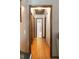 Long hallway with light walls and wood flooring leads to bedrooms and bath at 1830 Brandy Se Ln, Conyers, GA 30013