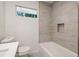 Modern bathroom with gray tile and bathtub at 2256 Barge Sw Rd, Atlanta, GA 30331