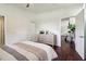 Well-lit bedroom with hardwood floors and access to another room at 2256 Barge Sw Rd, Atlanta, GA 30331