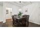 Bright dining room with dark wood table and chairs, hardwood floors, and stylish light fixture at 2256 Barge Sw Rd, Atlanta, GA 30331