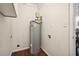 Laundry area featuring a new hot water heater and shelving at 2256 Barge Sw Rd, Atlanta, GA 30331