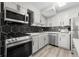 Modern kitchen with gray cabinets, stainless steel appliances and hexagon backsplash at 2965 Pharr Court South Nw # 304, Atlanta, GA 30305