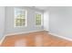 Bright bedroom with hardwood floors and multiple windows at 526 Bass Pointe Nw, Kennesaw, GA 30144