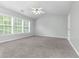 Main bedroom with ceiling fan, carpet, and large windows at 526 Bass Pointe Nw, Kennesaw, GA 30144