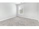 Spacious bedroom with gray carpet and large window at 526 Bass Pointe Nw, Kennesaw, GA 30144