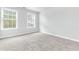 Well-lit bedroom featuring gray carpeting and two windows at 526 Bass Pointe Nw, Kennesaw, GA 30144