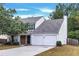 Two-story house with a two-car garage and landscaped lawn at 526 Bass Pointe Nw, Kennesaw, GA 30144