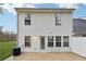 Rear view of townhouse with white siding and patio at 6235 Queen Meadow Se Dr, Mableton, GA 30126