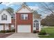 Front view of brick and siding townhouse with garage at 6235 Queen Meadow Se Dr, Mableton, GA 30126