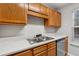 Kitchen with wood cabinets and double sink at 6235 Queen Meadow Se Dr, Mableton, GA 30126