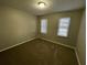 Simple bedroom with neutral walls and plush brown carpeting at 1921 Clinton Pl, Lawrenceville, GA 30043