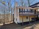 House exterior showcasing a deck, wooden railings, and a tranquil wooded backdrop at 1921 Clinton Pl, Lawrenceville, GA 30043