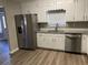 Updated kitchen, featuring stainless steel appliances and white cabinets at 1921 Clinton Pl, Lawrenceville, GA 30043