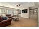 Spacious basement with a large sectional sofa and built-in shelving at 2082 Greenway Mill Ct, Snellville, GA 30078