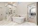 Luxurious bathroom with soaking tub, walk-in shower, and marble flooring at 2082 Greenway Mill Ct, Snellville, GA 30078