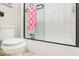 Bathroom with toilet, bathtub, and pink checkered towels at 2082 Greenway Mill Ct, Snellville, GA 30078