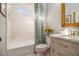 Elegant bathroom with marble tile, a shower/tub combo, and updated fixtures at 2082 Greenway Mill Ct, Snellville, GA 30078