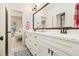 Bathroom with double vanity, large mirror, and white cabinets at 2082 Greenway Mill Ct, Snellville, GA 30078