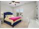 Bedroom with blue upholstered bed, yellow bedding, and white desk at 2082 Greenway Mill Ct, Snellville, GA 30078