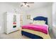 Well-lit bedroom with white armoire and blue bed frame at 2082 Greenway Mill Ct, Snellville, GA 30078