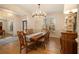 Elegant dining room with hardwood floors, chandelier, and large windows at 2082 Greenway Mill Ct, Snellville, GA 30078